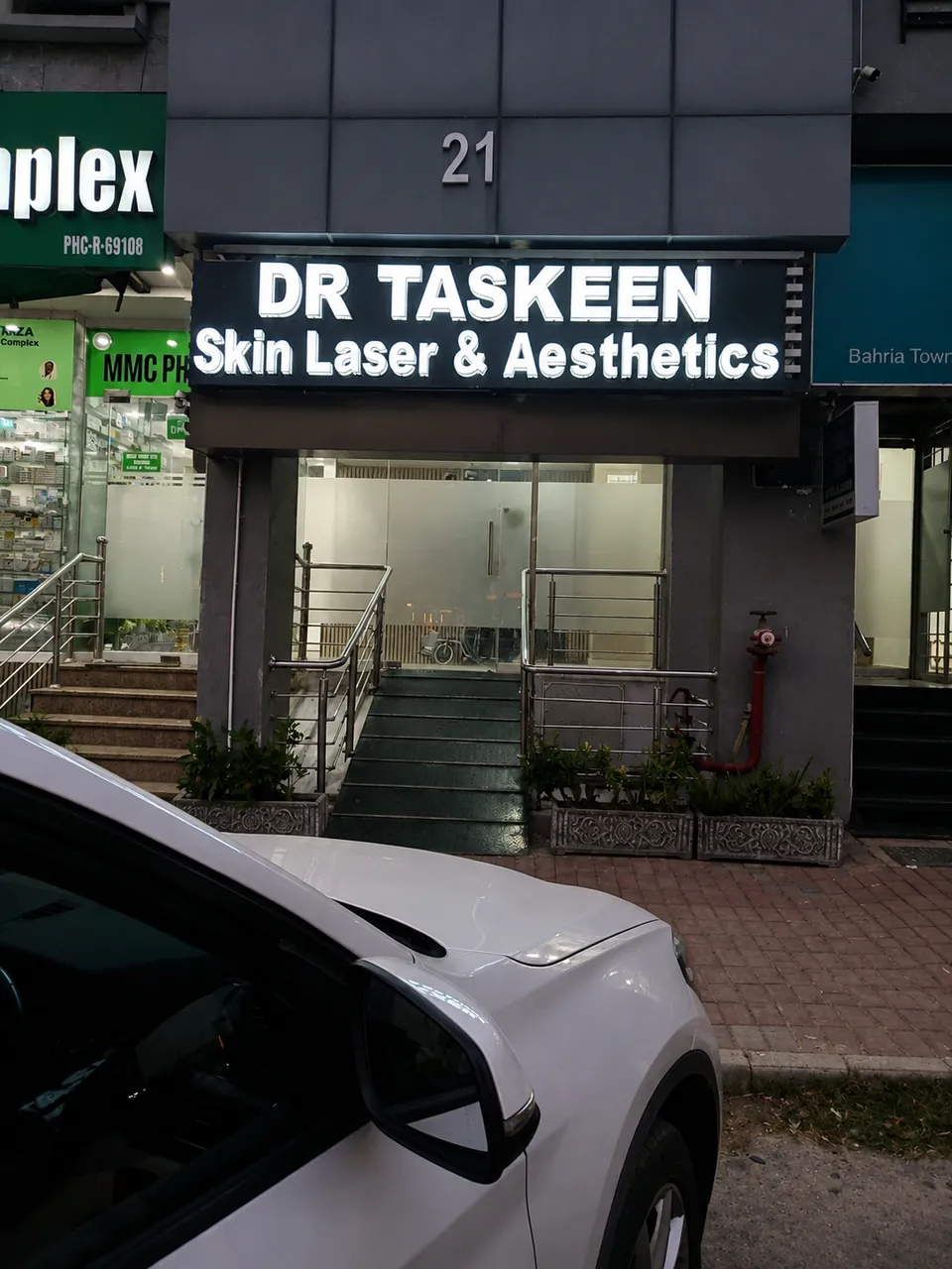 Dr Taskeen Iqbal Skin, Laser & Aesthetics clinic exterior with illuminated signage in Bahria Town, Rawalpindi